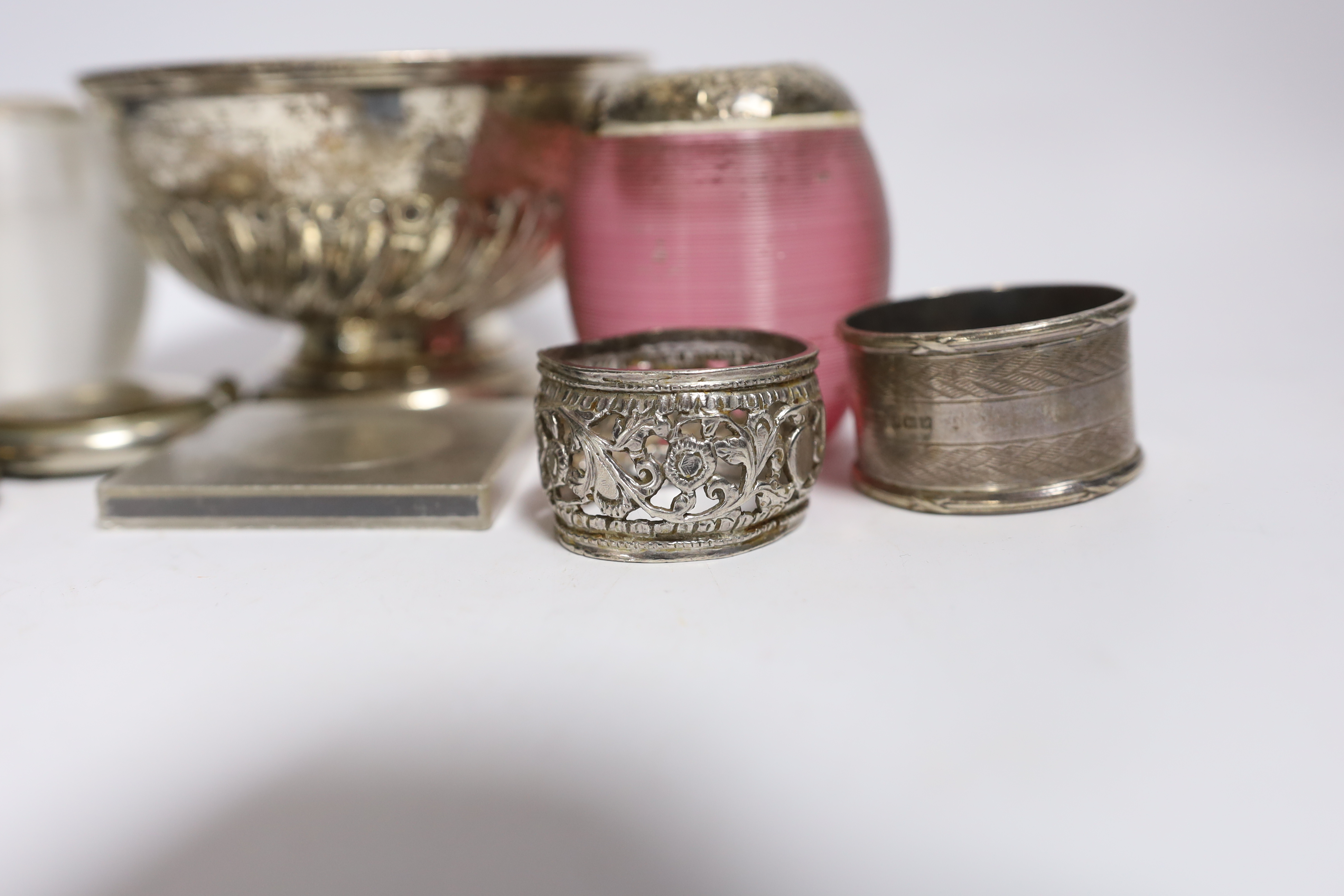A collection of small silver, to include two mounted glass match strikes, one with cranberry glass, 71mm, a demi fluted bowl, photograph frame, napkin ring, lid and pocket watch, together with one other pocket watch, a c